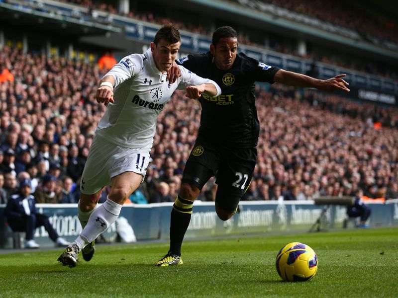 ...while Gareth Bale and Ivan Ramis vie for the ball