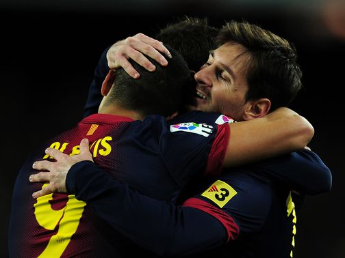 Lionel Messi (r) celebrates his first goal