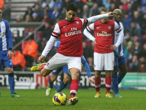 Mikel Arteta slots home the winning penalty