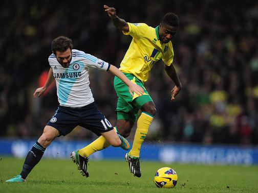 Juan Mata and Alex Tettey battle for the ball