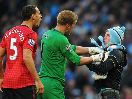 Joe Hart gets between Ferdinand and the fan