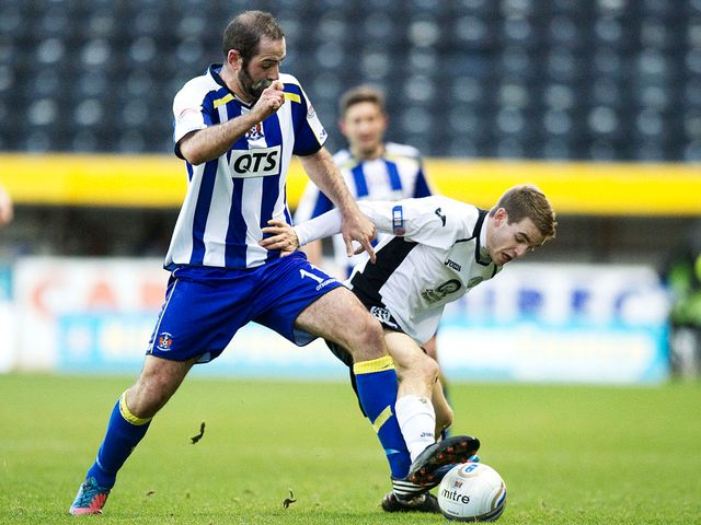 Gary Harkins battles for the ball with Daniel Carmichael