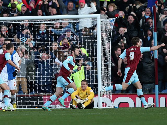 Sam Vokes races away to enjoy Burnley's equaliser.