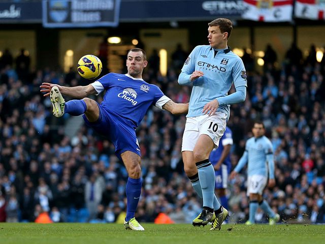 Darron Gibson and Edin Dzeko battle for the ball