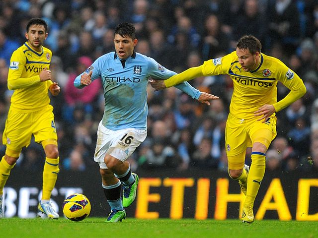 Sergio Aguero and Chris Gunter battle for the ball