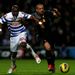 Jose Enrique is challenged by QPR's Stephane Mbia as the Reds go on to win 3-0 at Loftus Road