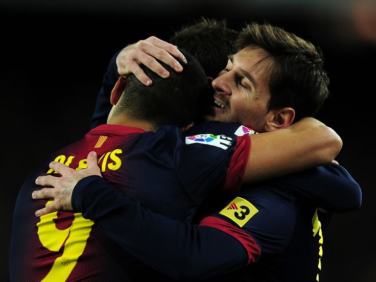 Lionel Messi (r) celebrates his first goal