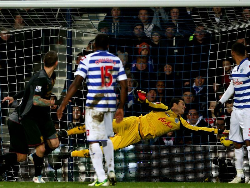 Goalkeeper Julio Cesar of QPR dives in vain as Liverpool's Daniel Agger scores his side's third goal.