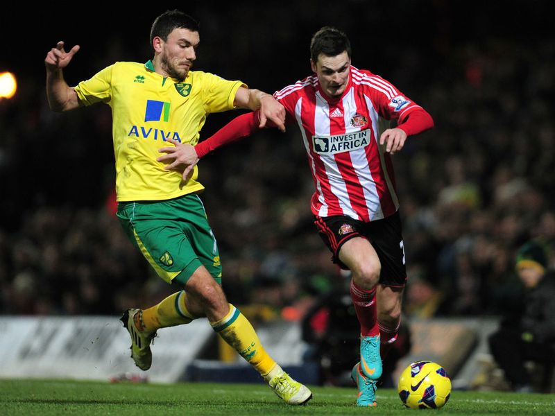 Adam Johnson holds off the challenge by Robert Snodgrass as the visitors push forward