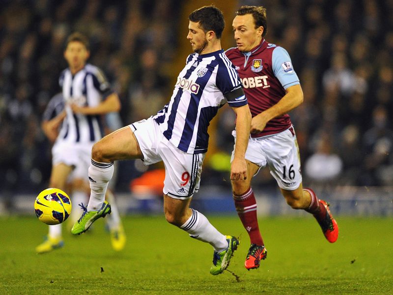 West Ham midfielder Mark Noble ensures West Brom striker Shane Long has little time in possession
