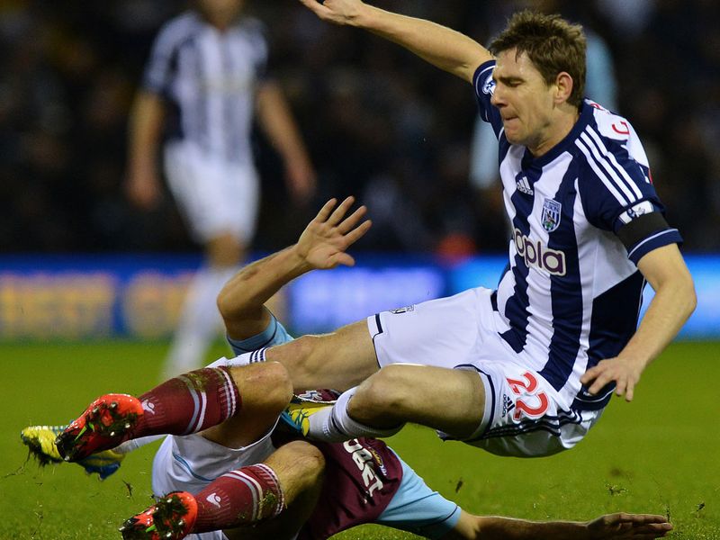 Kevin Nolan is on the wrong end of a strong challenge from West Brom's Zoltan Gera