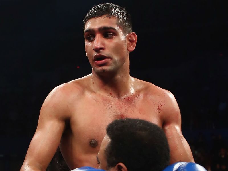 Khan is lifted in the air after Molina's corner pull their man out before the 11th round