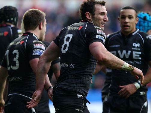 Ospreys celebrate after scoring a try