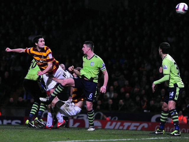 Carl McHugh heads home Bradford's third goal