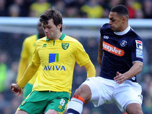 Jonny Howson is challenged by Andre Gray