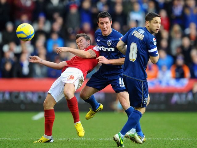 Simon Cox and Cliff Byrne battle for the ball