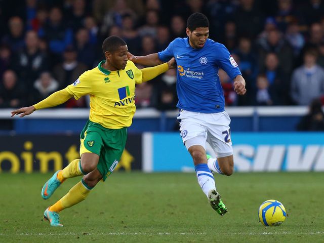 Simeon Jackson and Nat Knight Percival battle for the ball