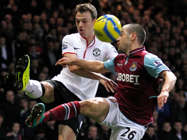 Jonny Evans and Joe Cole battle for the ball