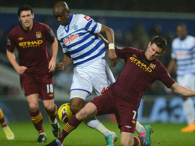 Stephane Mbia and James Milner battle for the ball