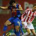 Mile Jedinak and Stoke's Peter Crouch are not quite sure where the ball is as they clash in the air