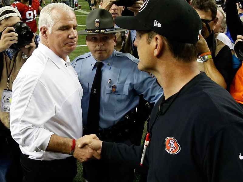 Harbaugh and Smith shake hands after the game
