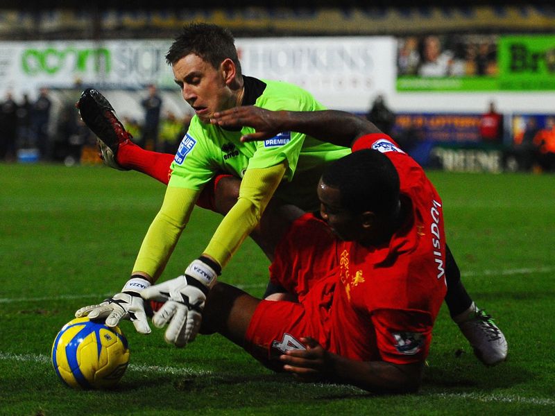 Alan Marriott in the Mansfield goal does a good job of keeping the Liverpool threat at bay.