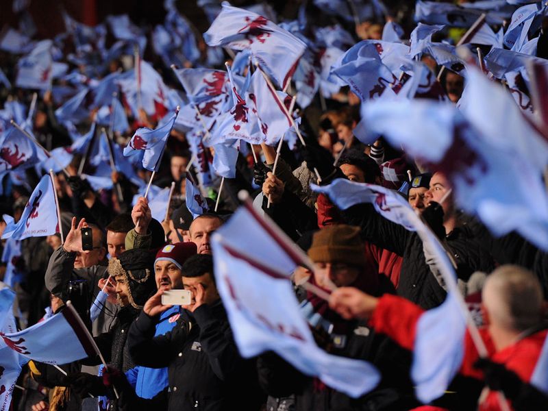 The home fans wave flags in support of their side ahead of kick-off at Villa Park