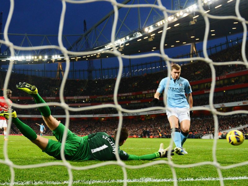 Making amends: Edin Dzeko makes up for his earlier penalty miss by scoring Manchester City's second goal past Wojciech Szczesny