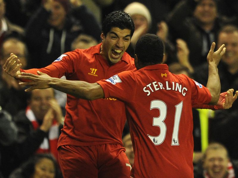 Sterling celebrates with Luis Suarez, scorer of Liverpool's second