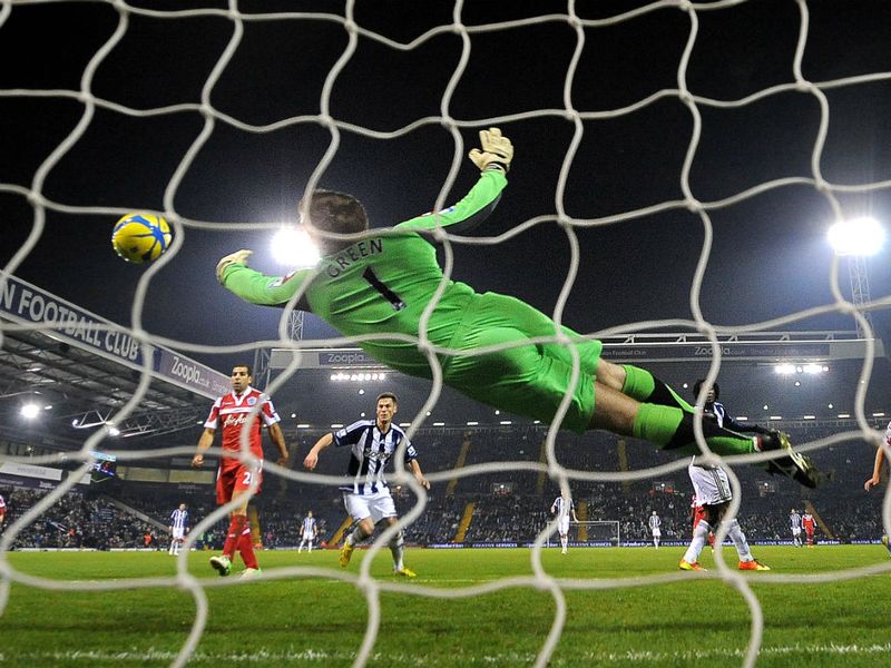 QPR goalkeeper Robert Green dives across his goal to make a great save at Loftus Road