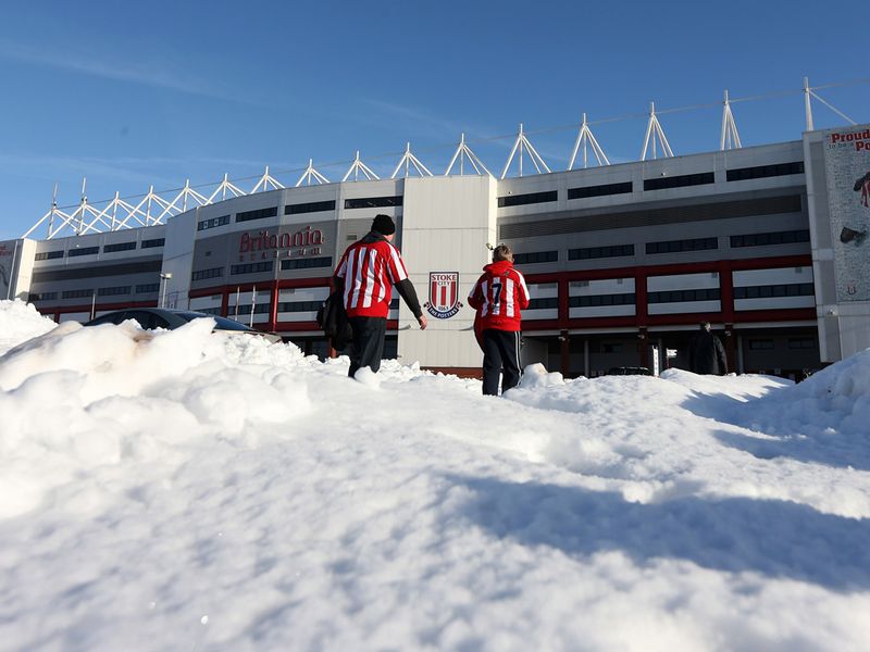Stoke fans make their way through the snow at the Britannia Stadium ahead of their team's FA Cup fourth-round clash with Manchester City