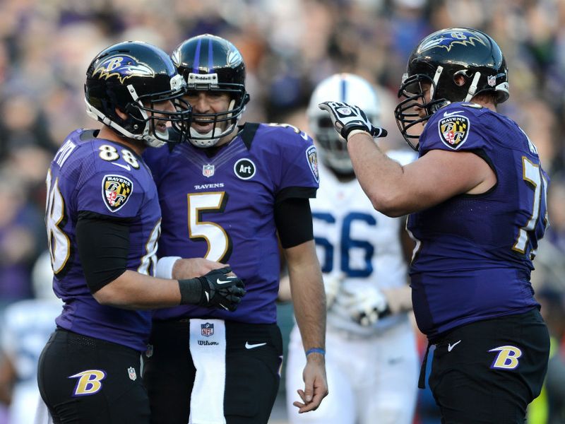 Joe Flacco (centre) celebrates with Dennis Pitta (left) after the duo combined for a third-quarter touchdown.