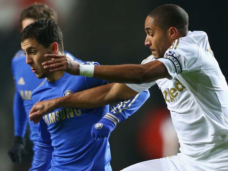 Chelsea's Hazard vies for the ball with impressive Swansea captain Ashley Williams during the opening minutes of the cup showdown.