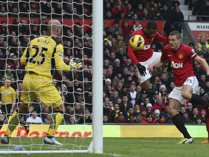 Second goal: Patrice Evra's header hits Nemanja Vidic and goes in for Manchester United to open up a two-goal lead...