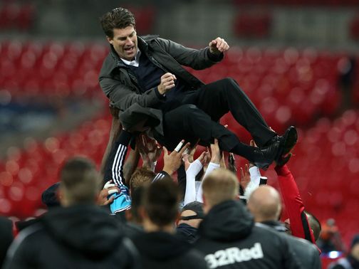 Swansea boss Michael Laudrup celebrates at Wembley.