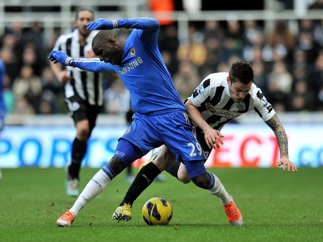 Demba Ba holds off Mathieu Debuchy.