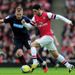 Mikel Arteta in full stride under the watchful eye of Jordan Rhodes