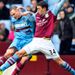 Matthew Lowton goes full-stretch to try and dispossess Hammers midfielder Matthew Taylor.