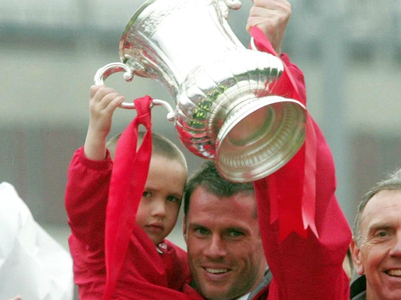 Carragher celebrates winning the FA Cup in 2006 with his son