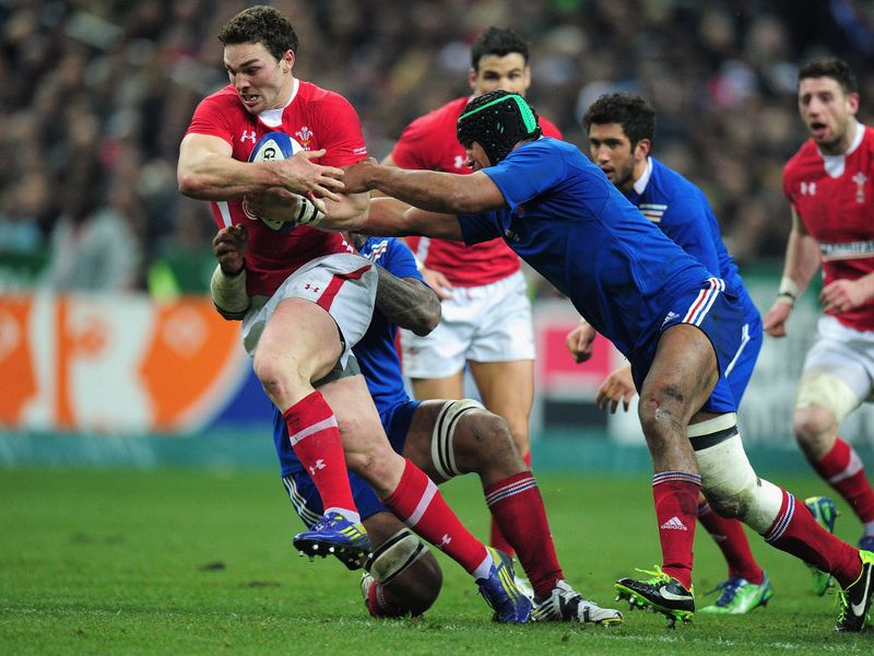 Tackles fly in: George North has two Frenchmen on him