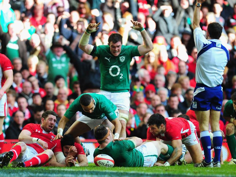 ...whose touchdown is celebrated by team-mates as Wales players Alex Cuthbert (l) and Mike Phillips look on dejectedly