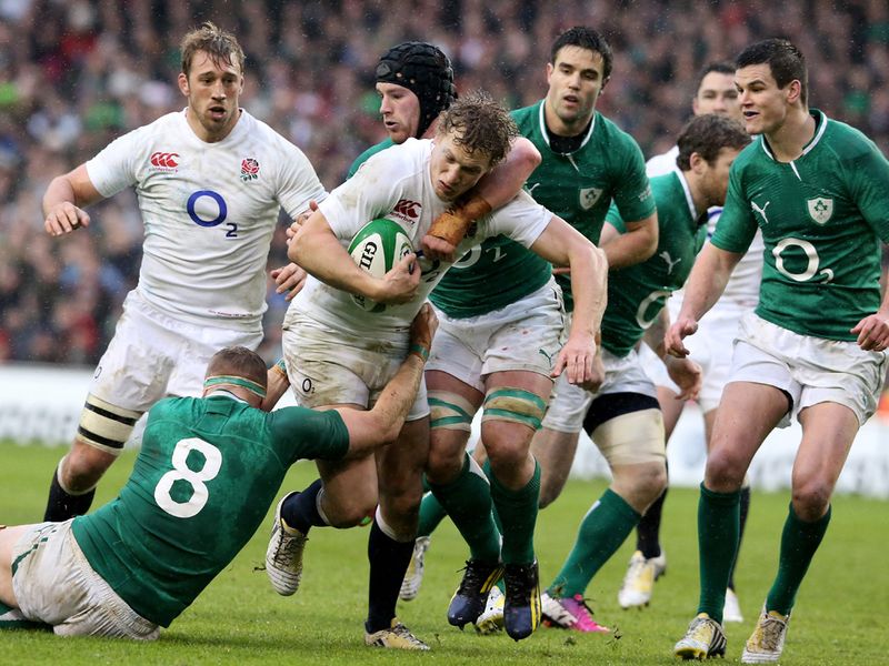 Double tackle: Billy Twelvetrees of England is stopped by Jamie Heaslip and Sean O'Brien
