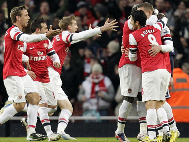 Lukas Podolski is congratulated after netting a late winner for Arsenal.