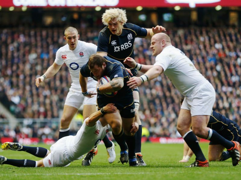 Trying hard: Ryan Grant of Scotland is tackled by Ben Youngs (left) and Dan Cole