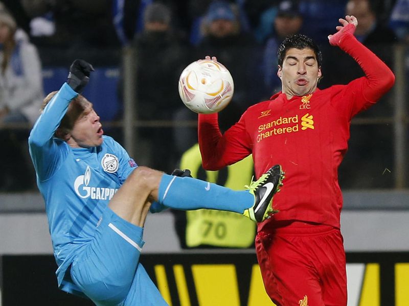 Luis Suarez competes for Liverpool