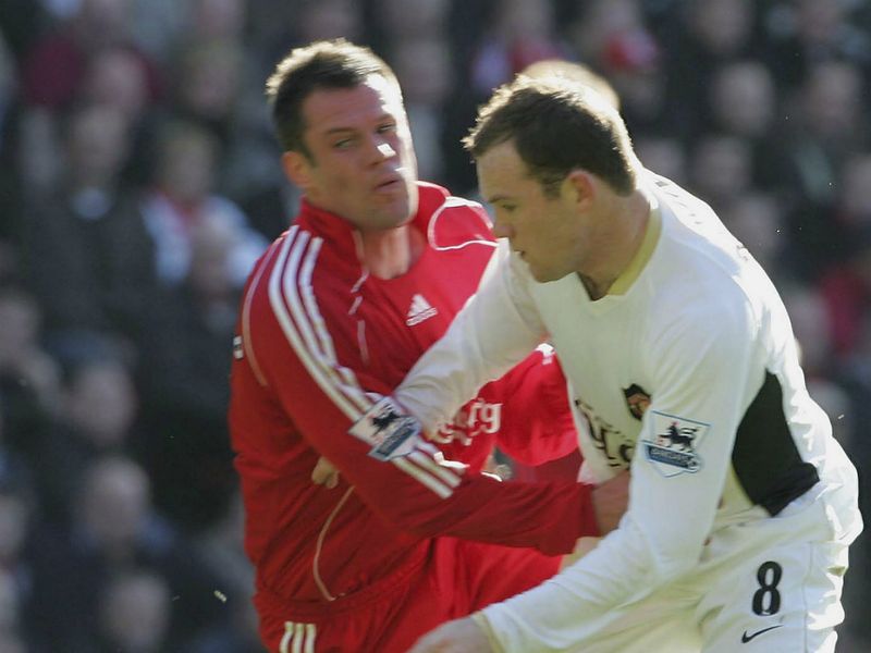 Carragher locks horns with Manchester United forward Wayne Rooney