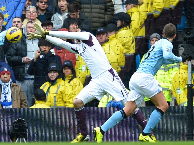 Petr Cech makes a crucial save to deny Matija Nastasic's header in a goalless first half.
