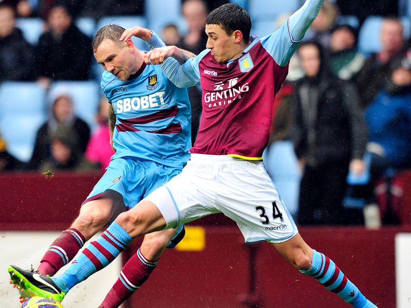 Matthew Lowton goes full-stretch to try and dispossess Hammers midfielder Matthew Taylor.