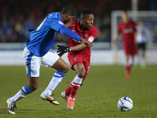 Mark Little and Callum Harriott battle for the ball