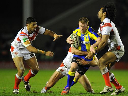 Chris Riley is tackled by Willie Manu and Sia Soliola